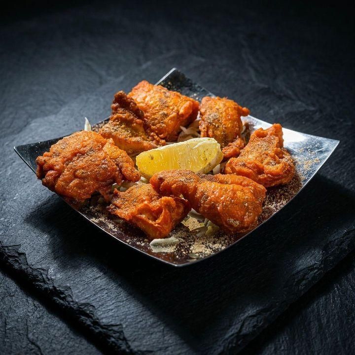 Crispy fish pakora with lemon at Taj Indian Cuisine & Bar in Madison, Wisconsin