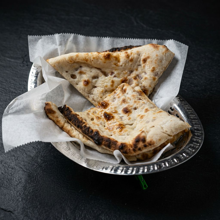 Onion kulcha bread in a silver basket at Taj Indian Cuisine & Bar in Madison, Wisconsin