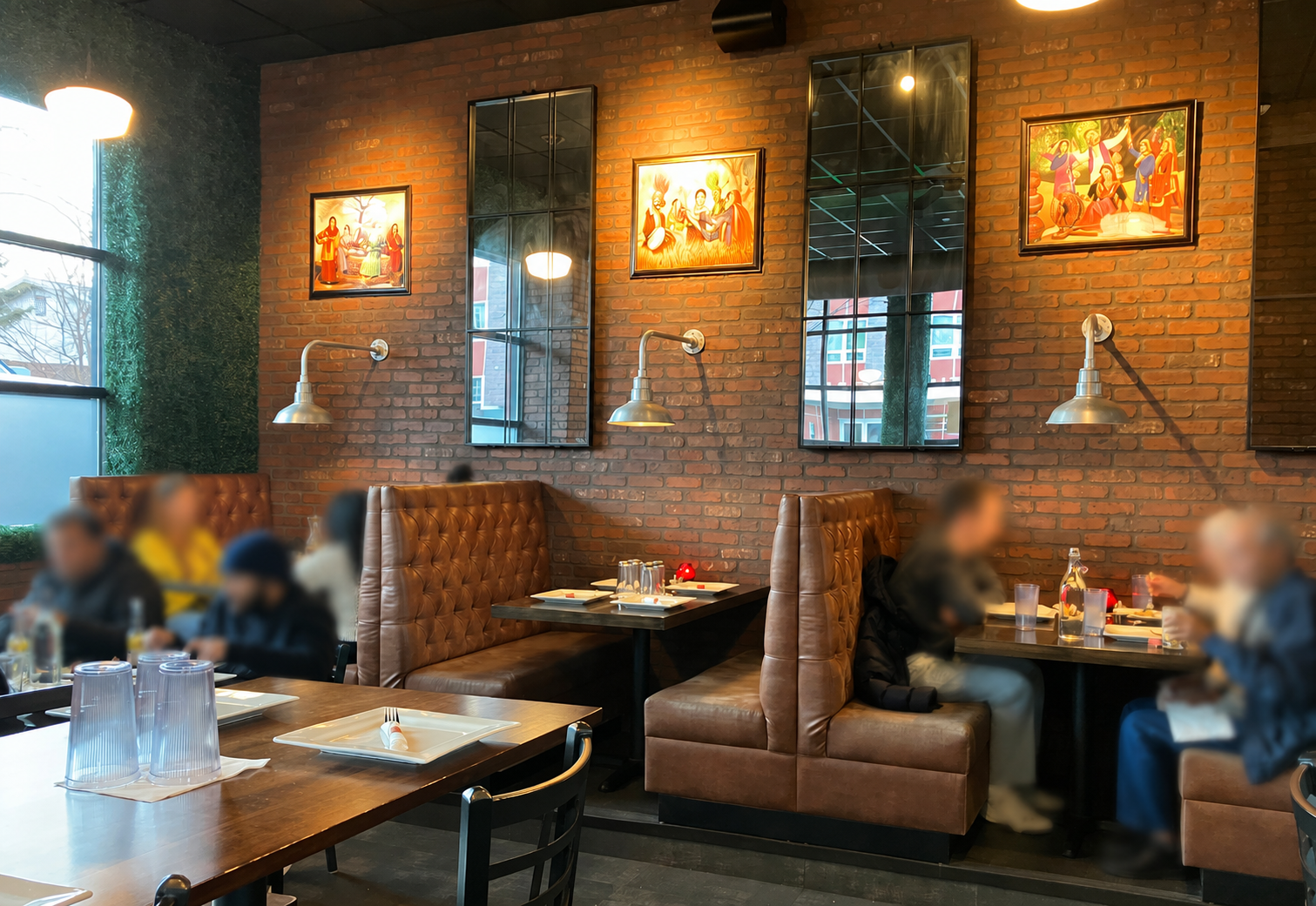 Dining room with brick wall and leather booths at Taj Indian Cuisine & Bar in Madison, Wisconsin